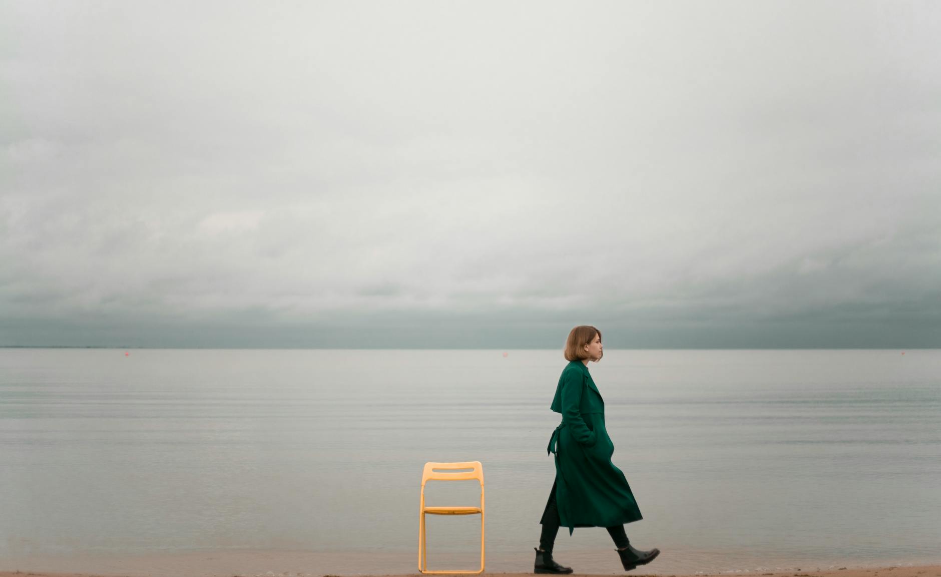 person walking on seashore